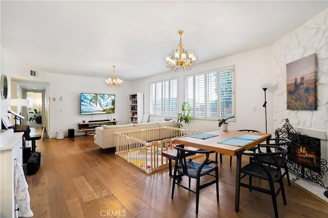 241 S Reeves Dr Unit 302, Beverly Hills, CA 90212 - dining area featuring a chandelier and hardwood / wood-style floors