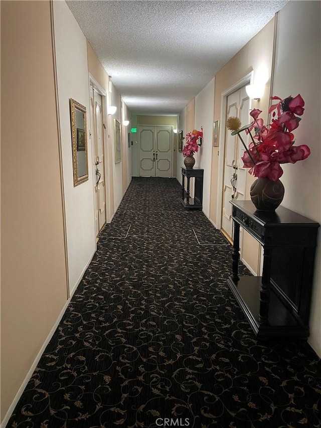 241 S Reeves Dr Unit 302, Beverly Hills, CA 90212 - corridor with a textured ceiling and carpet floors