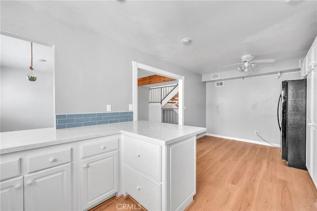 6325 Ridgepath Ct, Rancho Palos Verdes, CA 90275 - kitchen with freestanding refrigerator, a peninsula, white cabinetry, ceiling fan, and light wood-style floors