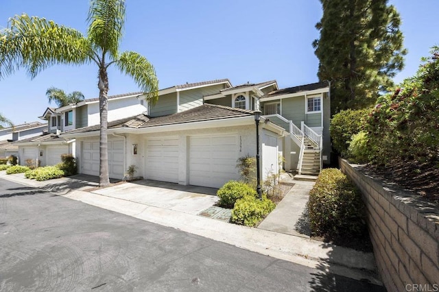 13398 Tiverton Rd, San Diego, CA 92130 - multi unit property featuring a garage, driveway, a tile roof, and stucco siding