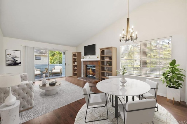 13398 Tiverton Rd, San Diego, CA 92130 - dining area featuring a brick fireplace, a chandelier, wood finished floors, and high vaulted ceiling