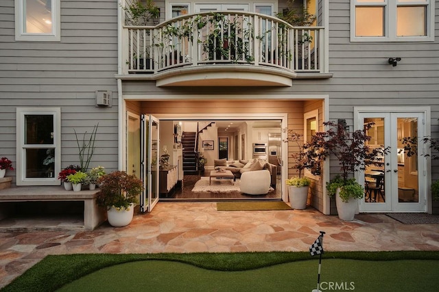 178 Flower St, Costa Mesa, CA 92627 - back of property with a balcony, french doors, an area to practice putting, and a patio