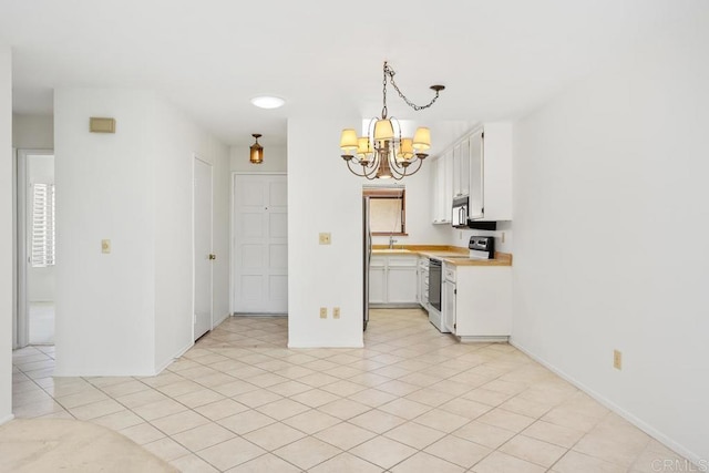 1640 Forestdale Dr, Encinitas, CA 92024 - kitchen featuring range with electric cooktop, a chandelier, light countertops, white cabinets, and pendant lighting