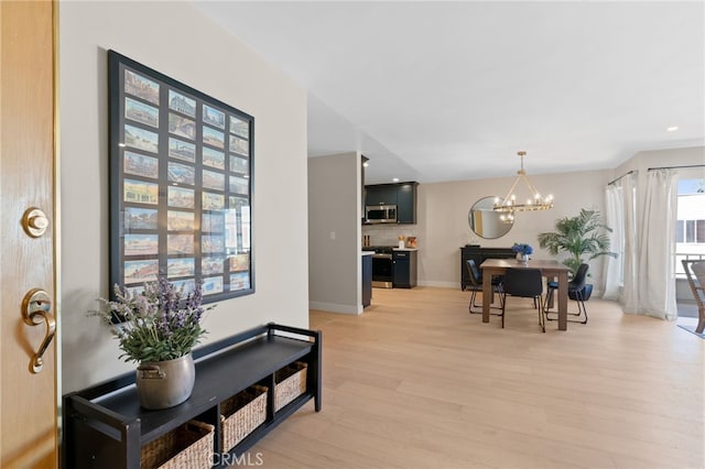 10707 Camarillo St Unit 314, North Hollywood, CA 91602 - living room featuring a chandelier, light wood-type flooring, baseboards, and recessed lighting