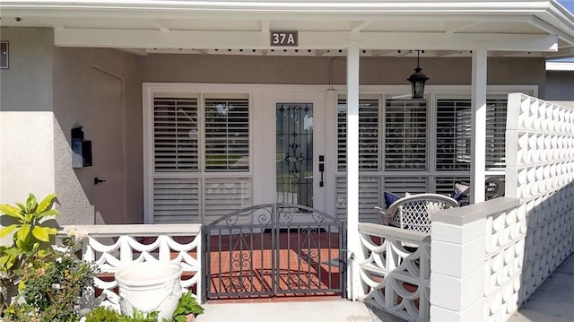 13800 Annandale Dr Unit 37A, Seal Beach, CA 90740 - property entrance with a gate, stucco siding, and a porch