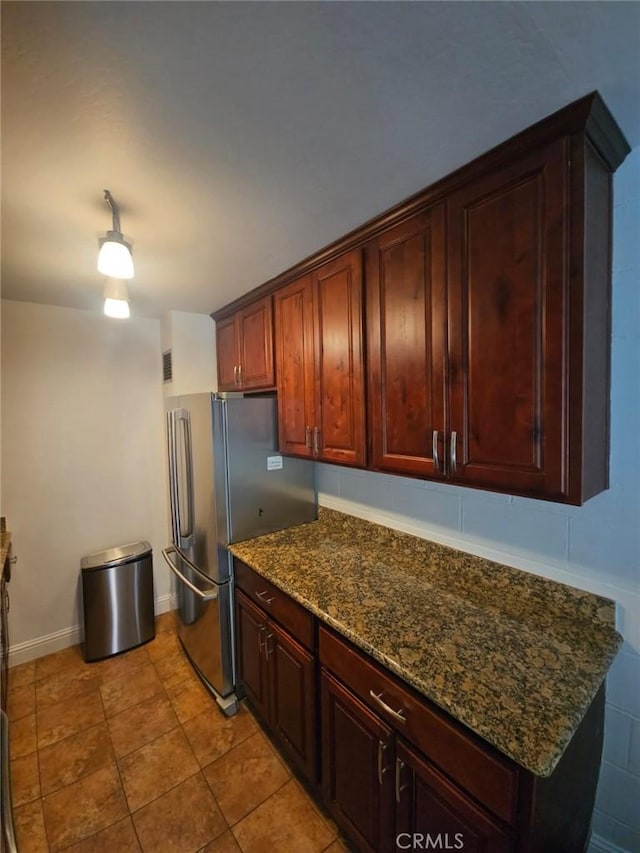 75 Western Shore Ln Unit 1, San Francisco, CA 94115 - kitchen with freestanding refrigerator, dark stone counters, baseboards, and light tile patterned floors