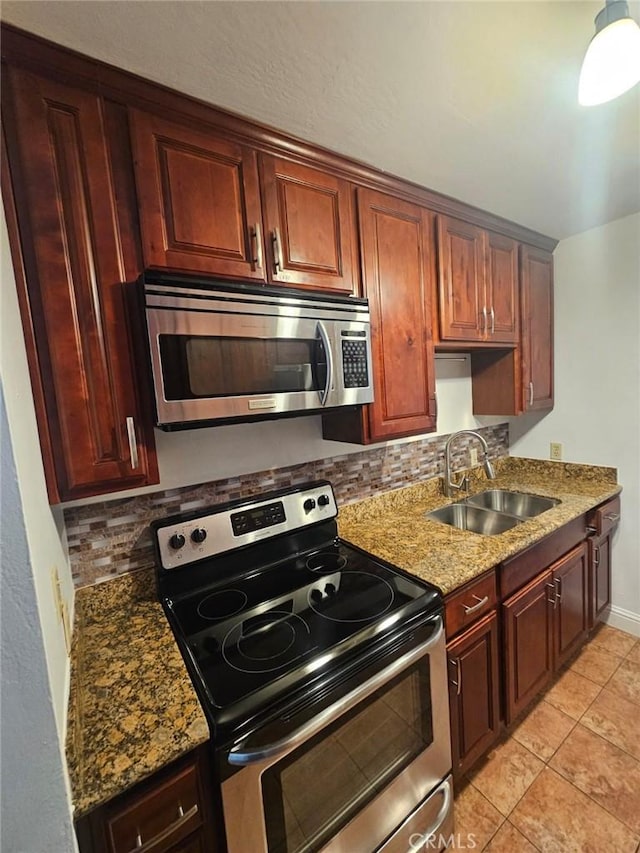 75 Western Shore Ln Unit 1, San Francisco, CA 94115 - kitchen featuring appliances with stainless steel finishes, a sink, backsplash, stone countertops, and light tile patterned floors