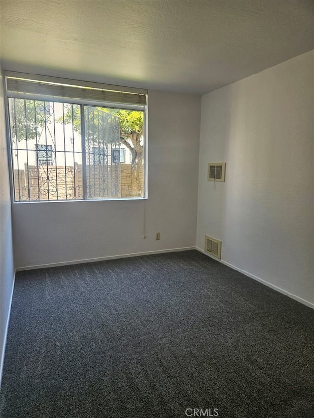 75 Western Shore Ln Unit 1, San Francisco, CA 94115 - spare room featuring dark colored carpet, baseboards, and a textured ceiling