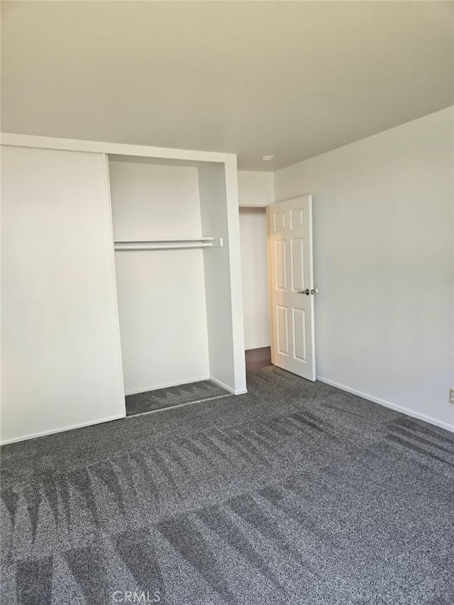 75 Western Shore Ln Unit 1, San Francisco, CA 94115 - unfurnished bedroom with dark colored carpet, baseboards, and a closet