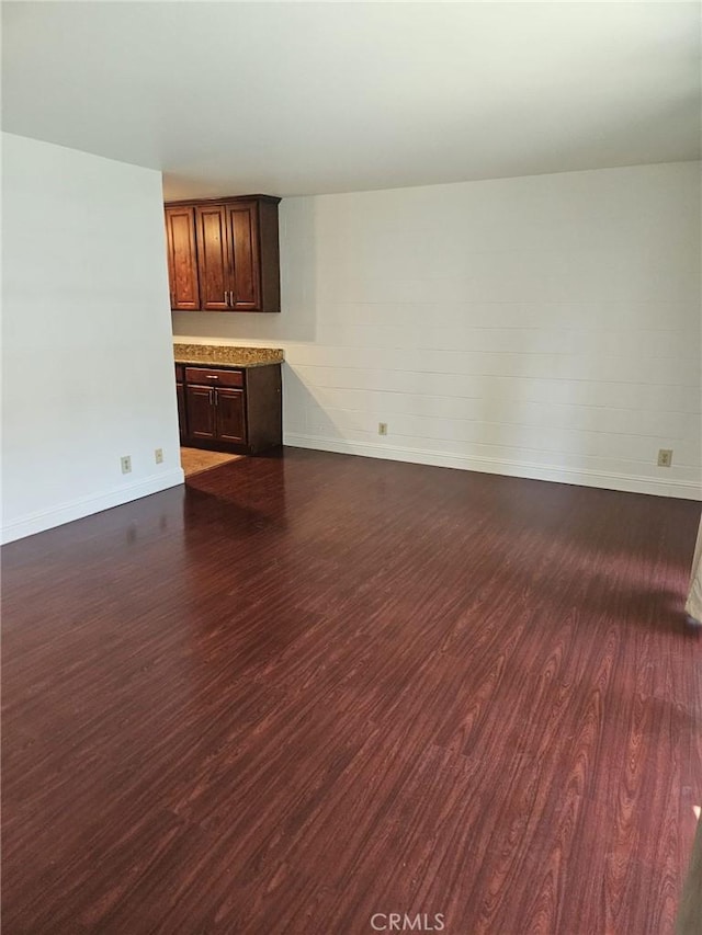 75 Western Shore Ln Unit 1, San Francisco, CA 94115 - unfurnished living room featuring dark wood-style flooring and baseboards