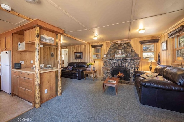 75 Metcalf Creek Trl, Big Bear Lake, CA 92315 - living area with carpet, wooden walls, and a stone fireplace