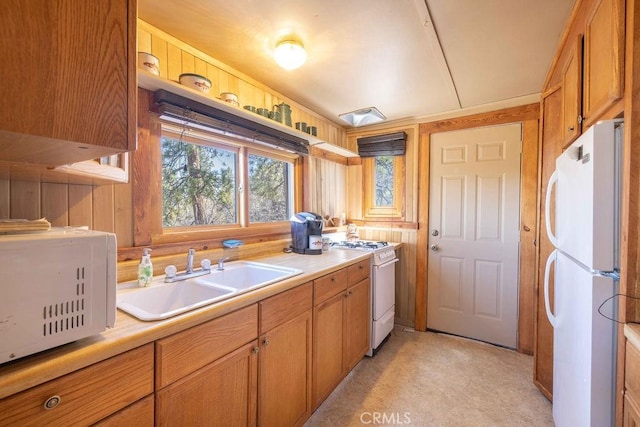 75 Metcalf Creek Trl, Big Bear Lake, CA 92315 - kitchen with white appliances, a sink, light countertops, and brown cabinets