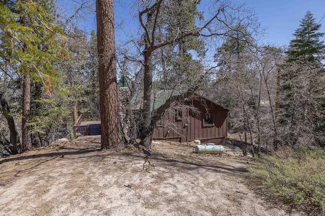 75 Metcalf Creek Trl, Big Bear Lake, CA 92315 - view of front facade with board and batten siding and a wooded view