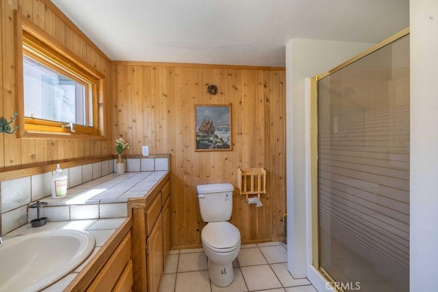 75 Metcalf Creek Trl, Big Bear Lake, CA 92315 - bathroom with a stall shower, toilet, wooden walls, vanity, and tile patterned floors