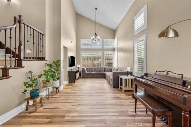 27360 Chesterfield Dr, Valencia, CA 91354 - living area with wood finished floors, a chandelier, high vaulted ceiling, baseboards, and stairway