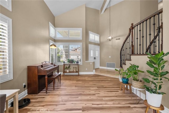 27360 Chesterfield Dr, Valencia, CA 91354 - entryway featuring light wood-style floors, high vaulted ceiling, stairway, and baseboards