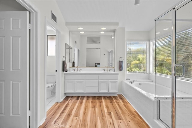27360 Chesterfield Dr, Valencia, CA 91354 - bathroom with double vanity, toilet, a bath, and wood finished floors