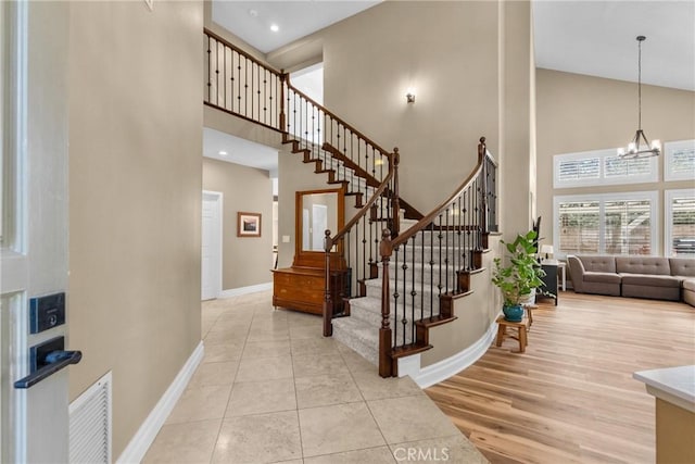 27360 Chesterfield Dr, Valencia, CA 91354 - entryway featuring a high ceiling, baseboards, stairs, a chandelier, and light wood-style flooring