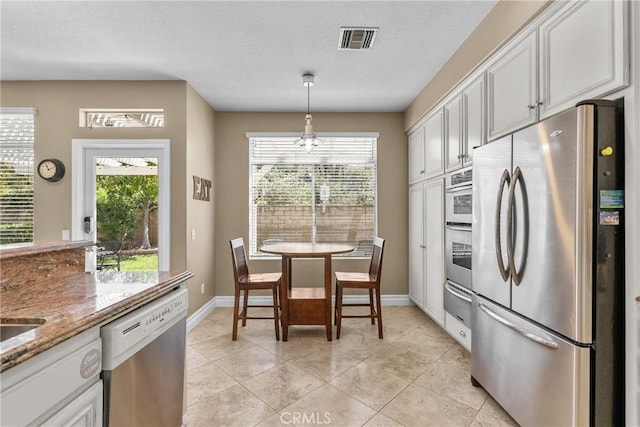 27360 Chesterfield Dr, Valencia, CA 91354 - kitchen featuring appliances with stainless steel finishes, a warming drawer, plenty of natural light, and baseboards