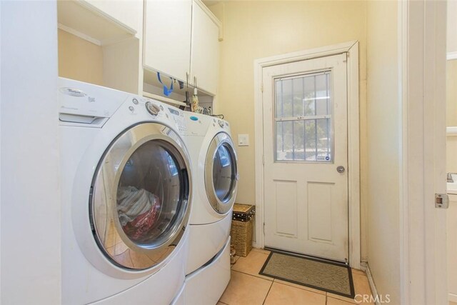 2712 Kenwood Ave, Los Angeles, CA 90007 - laundry area featuring cabinet space, separate washer and dryer, and light tile patterned floors
