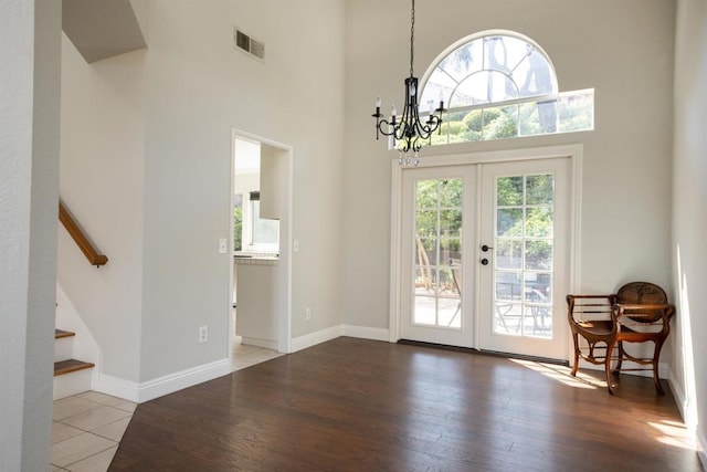 1688 Crystal Ridge Ct, Vista, CA 92081 - entryway featuring a chandelier, a towering ceiling, wood finished floors, french doors, and stairs