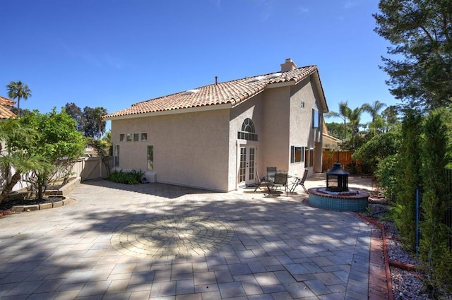 1688 Crystal Ridge Ct, Vista, CA 92081 - back of property featuring stucco siding, a patio, a fenced backyard, a tile roof, and a chimney