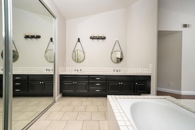 1688 Crystal Ridge Ct, Vista, CA 92081 - full bathroom featuring double vanity, a garden tub, and tile patterned flooring