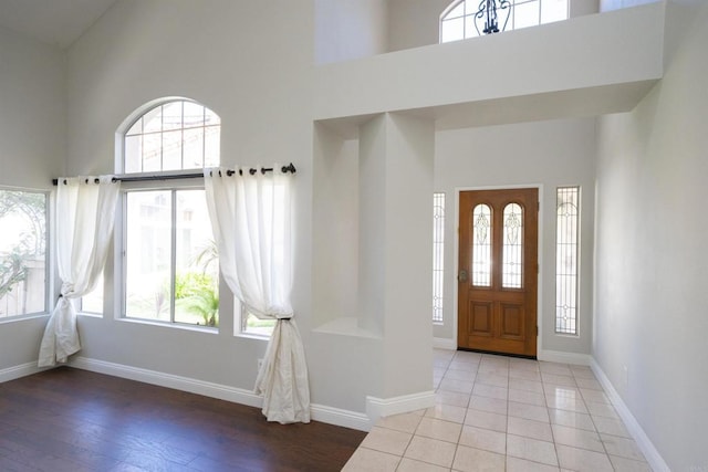 1688 Crystal Ridge Ct, Vista, CA 92081 - entryway with a towering ceiling, baseboards, and wood finished floors