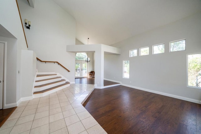 1688 Crystal Ridge Ct, Vista, CA 92081 - entrance foyer featuring stairway, high vaulted ceiling, plenty of natural light, tile patterned flooring, and baseboards