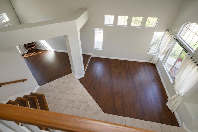 1688 Crystal Ridge Ct, Vista, CA 92081 - stairway featuring wood finished floors, baseboards, and a towering ceiling