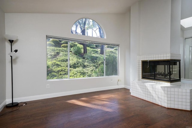 1688 Crystal Ridge Ct, Vista, CA 92081 - unfurnished living room featuring wood finished floors, baseboards, and a tiled fireplace