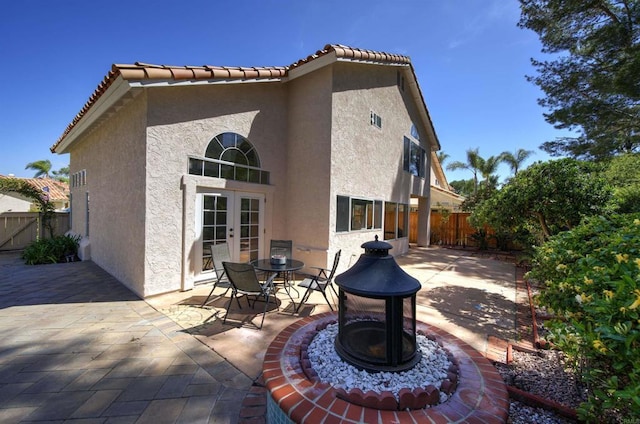 1688 Crystal Ridge Ct, Vista, CA 92081 - rear view of property featuring french doors, stucco siding, a patio, and a fenced backyard
