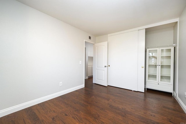 1688 Crystal Ridge Ct, Vista, CA 92081 - unfurnished bedroom featuring dark wood-style flooring, baseboards, and a closet