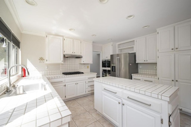 1688 Crystal Ridge Ct, Vista, CA 92081 - kitchen featuring stainless steel appliances, tile counters, open shelves, under cabinet range hood, and a sink