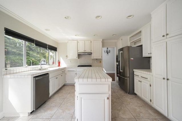 1688 Crystal Ridge Ct, Vista, CA 92081 - kitchen featuring stainless steel appliances, tile countertops, a sink, tasteful backsplash, and ornamental molding