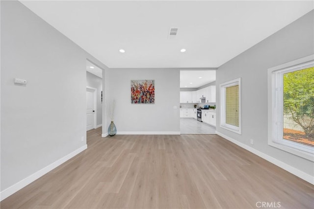 404 E Kingsley Ave, Pomona, CA 91767 - unfurnished living room featuring light wood finished floors, baseboards, and recessed lighting