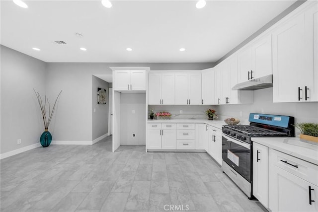 404 E Kingsley Ave, Pomona, CA 91767 - kitchen with gas range, under cabinet range hood, baseboards, recessed lighting, and white cabinetry