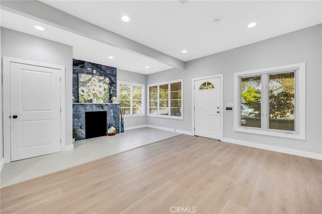 404 E Kingsley Ave, Pomona, CA 91767 - unfurnished living room featuring light wood-style floors, a high end fireplace, baseboards, recessed lighting, and beam ceiling