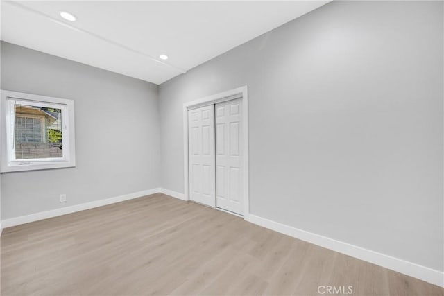 404 E Kingsley Ave, Pomona, CA 91767 - unfurnished bedroom with light wood finished floors, baseboards, a closet, and recessed lighting