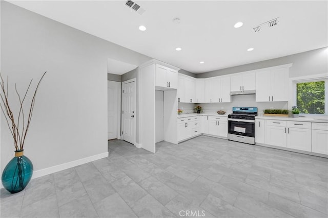 404 E Kingsley Ave, Pomona, CA 91767 - kitchen featuring stainless steel gas range, light countertops, under cabinet range hood, white cabinetry, and recessed lighting