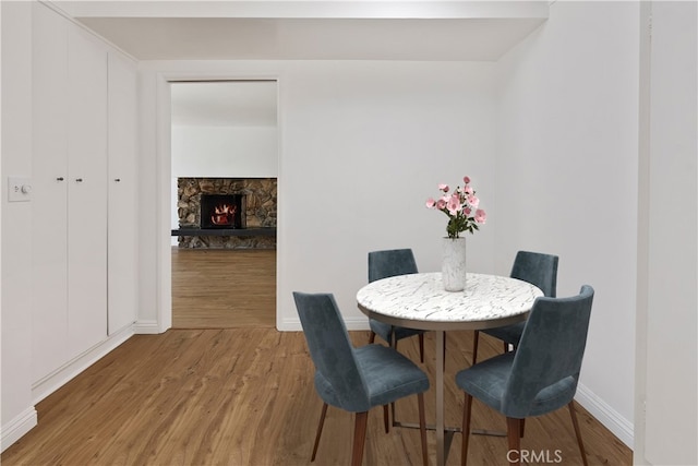 4312 Babcock Ave Unit 6, Studio City, CA 91604 - dining area featuring wood finished floors, baseboards, and a fireplace