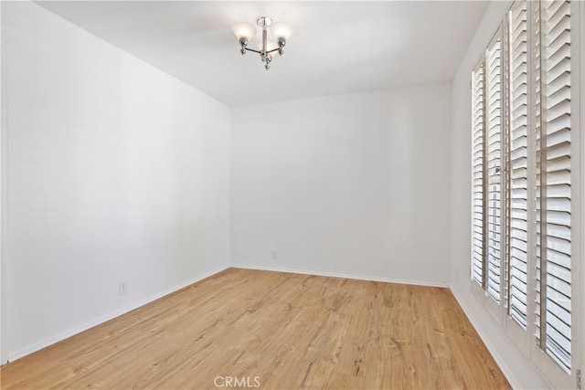 4312 Babcock Ave Unit 6, Studio City, CA 91604 - spare room featuring wood finished floors, a chandelier, healthy amount of natural light, and baseboards