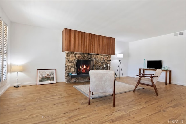 4312 Babcock Ave Unit 6, Studio City, CA 91604 - sitting room featuring light wood finished floors, a stone fireplace, baseboards, and a desk