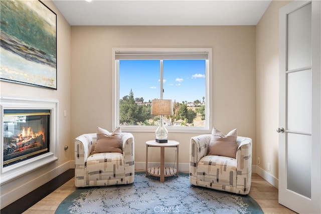 3048 Street Of The Chimes, Chino Hills, CA 91709 - living area featuring a glass covered fireplace and wood finished floors