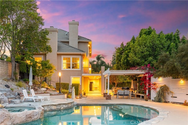 3048 Street Of The Chimes, Chino Hills, CA 91709 - rear view of property featuring a patio area, a chimney, stucco siding, a pergola, and a pool with connected hot tub