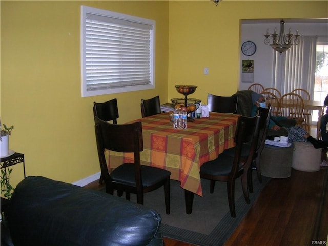 8358 Murietta Ave, Panorama City, CA 91402 - dining space with a chandelier, wood finished floors, and baseboards