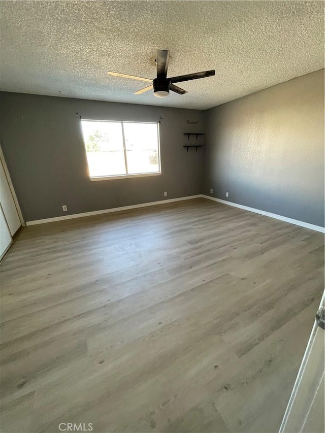 14199 Havasu Rd, Apple Valley, CA 92307 - empty room featuring ceiling fan, a textured ceiling, wood finished floors, and baseboards