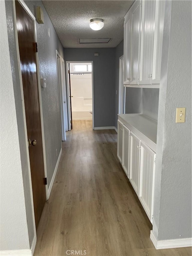 14199 Havasu Rd, Apple Valley, CA 92307 - hall with a textured ceiling, a textured wall, wood finished floors, and baseboards