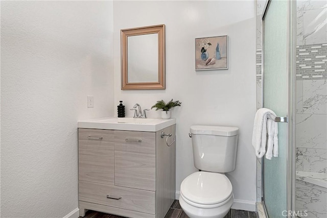 22331 Ramona Ave, Apple Valley, CA 92307 - bathroom with vanity, baseboards, toilet, a stall shower, and marble look tile flooring