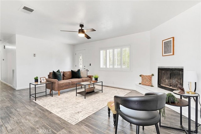 22331 Ramona Ave, Apple Valley, CA 92307 - living room with baseboards, ceiling fan, a glass covered fireplace, and wood finished floors